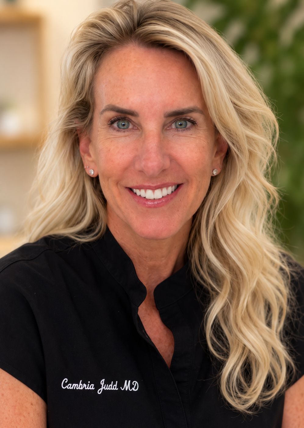 Dr. Cambria Judd in black scrubs, smiling, at the clinic.